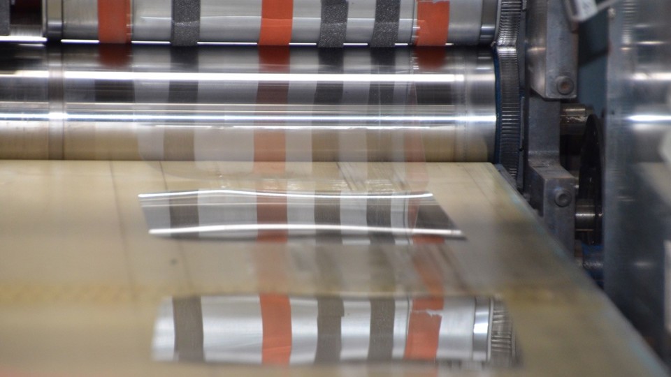 PET plastic medical face shields being cut on a die cutting press